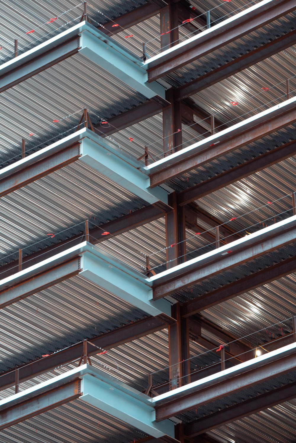 Exposed structural steel beams and metal decking at a construction site